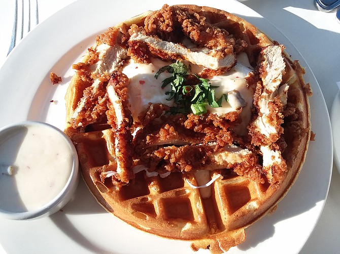 The gravy- with a little kick- is the secret to the chicken and waffles at Pacifica Breeze Cafe.