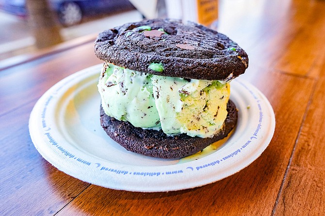 Ice cream sandwich with double chocolate chunk cookie, double chocolate mint cookie, and mint chocolate chip ice cream