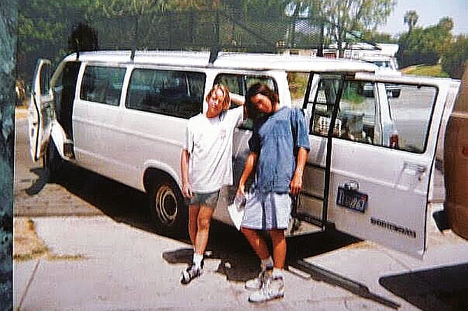 DeLeon and a friend get ready to go to work, 1990.
