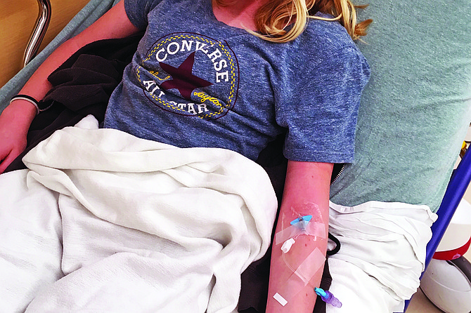Pain hurts- smiling despite getting an IV — after the morphine kicked in.