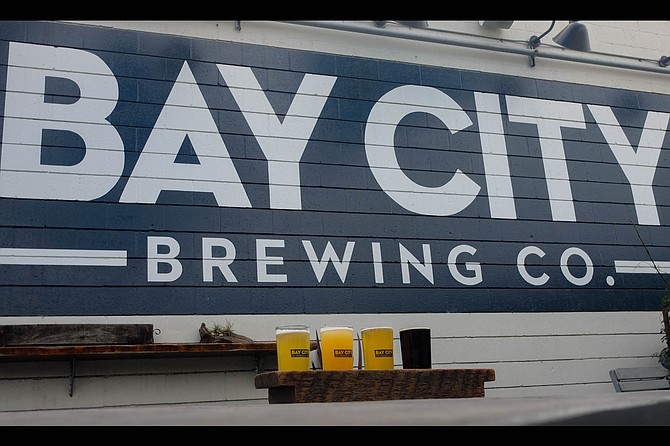A flight on the patio of Bay City Brewing