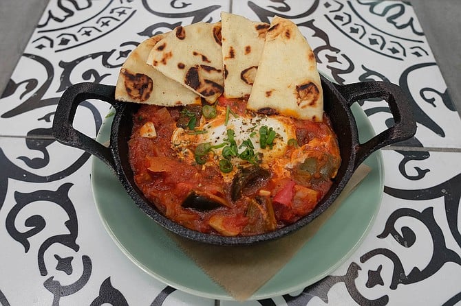 The traditional North African dish, shakshouka: poached egg in a stew of tomatoes and chili peppers