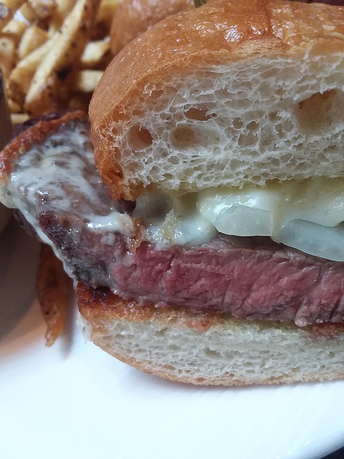 Thick slices of prime rib, caramelized onions, and provolone cheese on a French roll create the perfect sandwich.