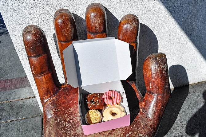 A hand-shaped chair holds a box of donuts at Peterson's Donut Corner.