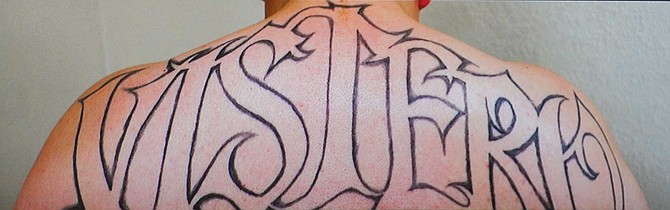 Photo of tattoo VISTERO across back of Vista Home Boy Jose Sorto
