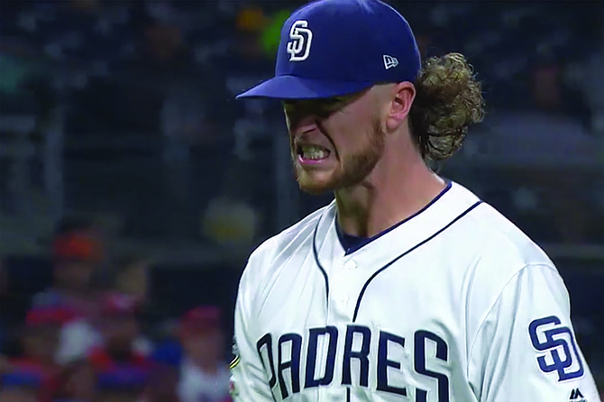 Padres pitching phenom Chris Paddack grimaces in pain following his celebration of striking out NL Rookie of the Month Pete Alonso of the Mets for the second time on May 6. “Paddack’s pitching mechanics are pretty much perfect,” commented Padres Trainer Raul Goodform. “So I wasn’t on the lookout for red flags warning he might be headed for Injured Reserve. Unfortunately, his amped-up arm pump tends to move across his body in awkward fashion, and it puts a strain on his rotator cuff. And when you have an April like he’s had — 1.91 ERA and 35 strikeouts in 33 innings — you tend to do a lot of pumping. Now he’s going to have to rest it a while. How long is hard to say: to be honest, I don’t have much experience with enthusiasm-based repetitive stress injuries.”