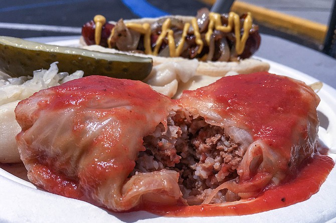 Stuffed cabbage, filled with ground beef, rice, and onions, smothered in tomato sauce