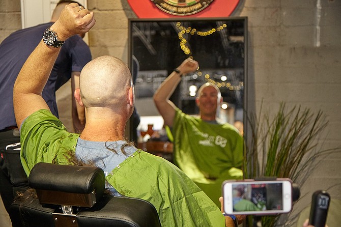 Brewer Mike Hess responds to having his head shaved for charity.