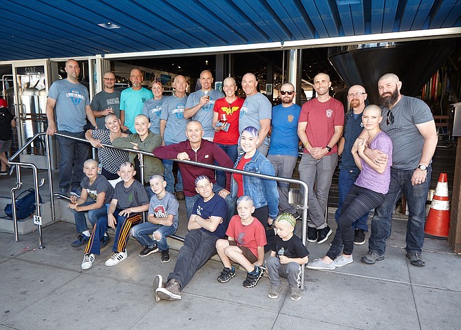 Just a few of the freshly shaved heads supporting a St. Baldrick’s fundraiser at Mike Hess Brewing in North Park. - Image by Tim  Stahl