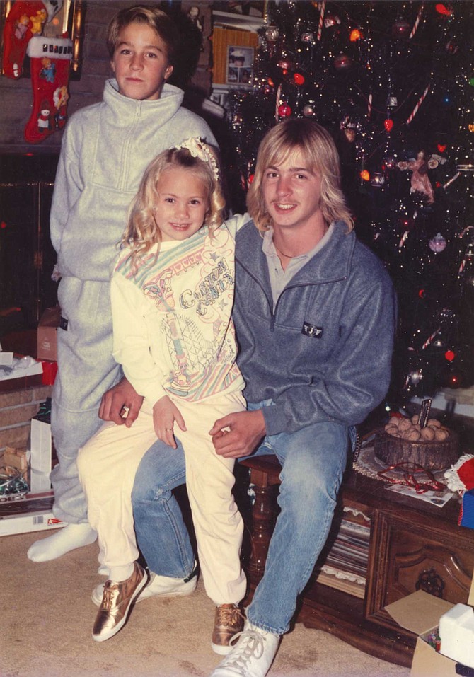 Young Kamaryn embraces Jamie during a 1980s Christmas celebration