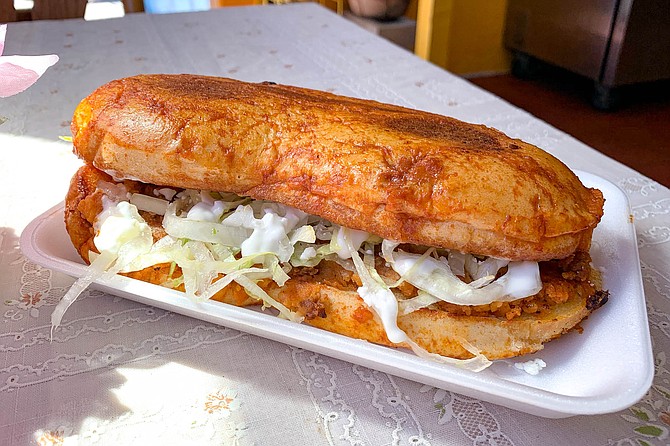A pombazo wet sandwich, with chorizo and potatoes