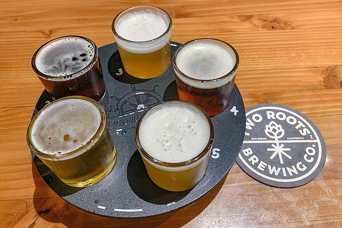 The Helm's Brewing logo has been scraped of this Two Roots flight tray.