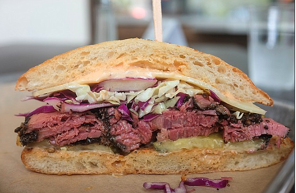 A Reuben-like sandwich with a house pastrami of hickory-smoked brisket, served on a ciabatta
