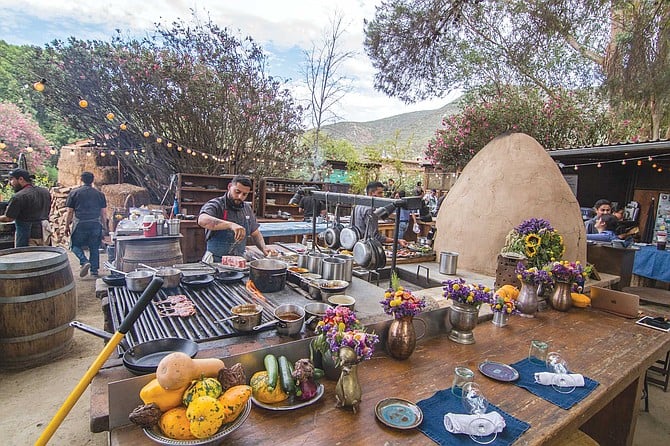 Enjoy the aromas wafting from the wood-fire, outdoor kitchen at Deckman’s en el Mogor