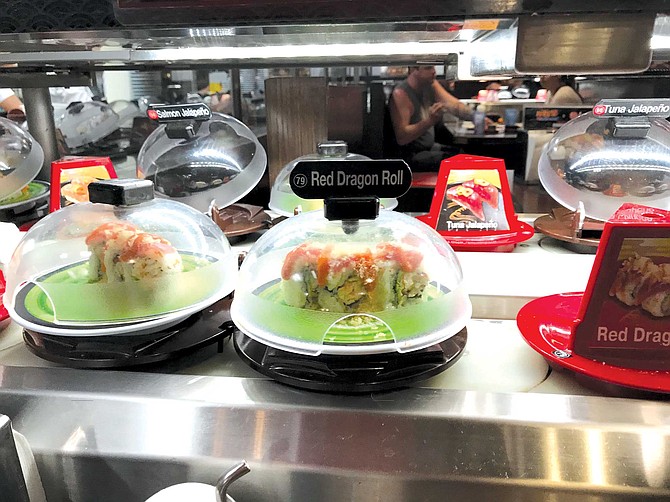 Each plate at Kura Revolving Sushi Bar only costs $2.60, and before you know it, you’ve had a dozen of these things.