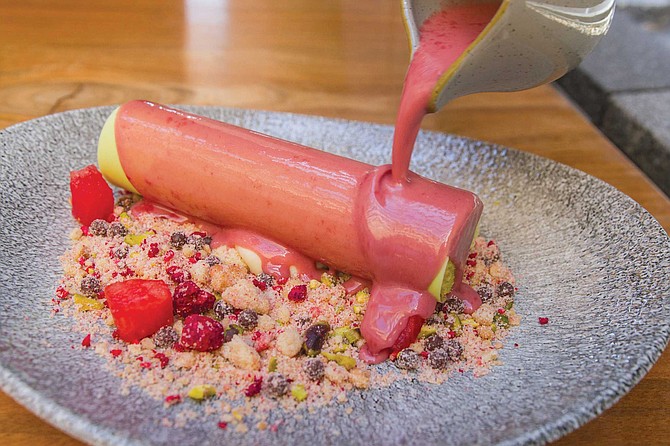 The summertime Yodel at Juniper & Ivy: frozen watermelon pudding encased in a white chocolate/pistachio shell on a bed of malt crunch, drizzled in warm raspberry ganache