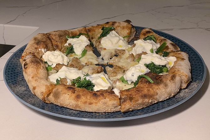 Rustichella pizza, with broccoli rapini, burrata, and sausage toppings
