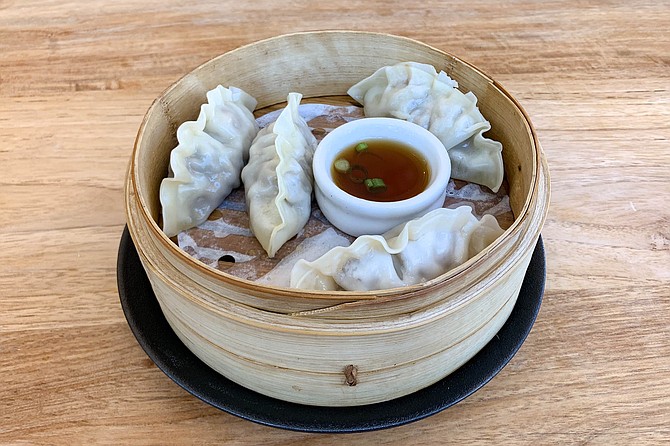 Steamed mandu dumplings, filled with beef, carrot, and onion meatballs
