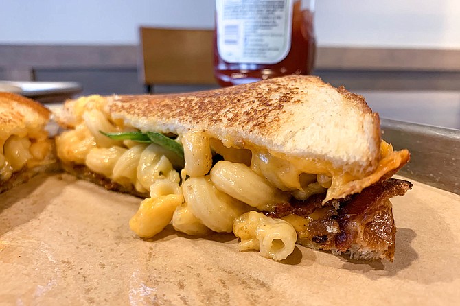 Macaroni , bacon,and too little spinach on a grilled cheese sandwich