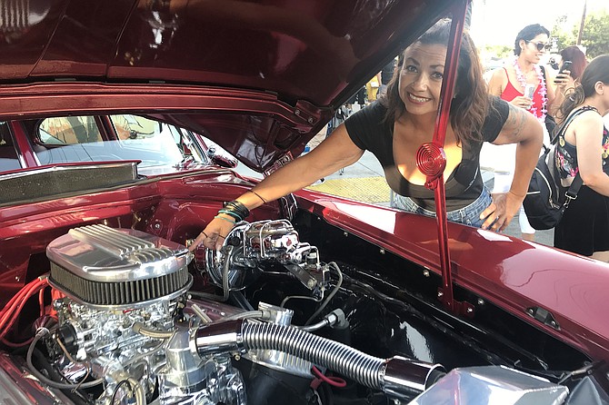 Marisa Rosales points to her outsize carburetor