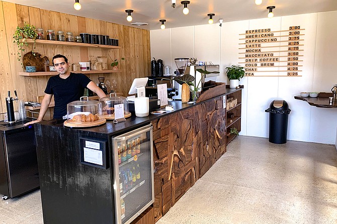 Jorge Diaz serving coffee at his new coffee bar, Claro Coffee