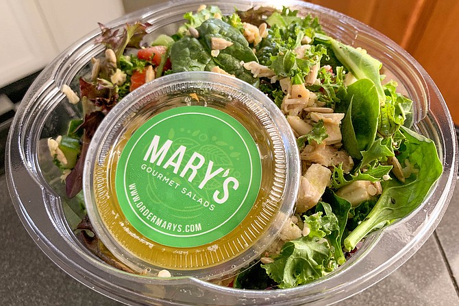 A citrusy salad dressing packaged with a chopped salad of chicken, greens, and veggies