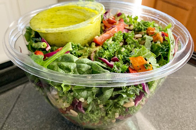 A six cup tub of chopped produce, with herbal green salad dressing