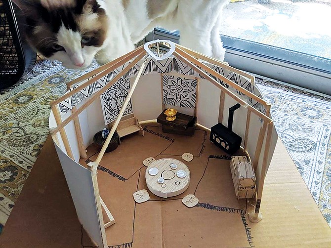 Model of a tent from issue 2 of Patrick and Jessica Reilly’s Five Realms comic series (cat for scale). Jessica creates the models to get a more accurate representation for how some of the characters interact with the world.