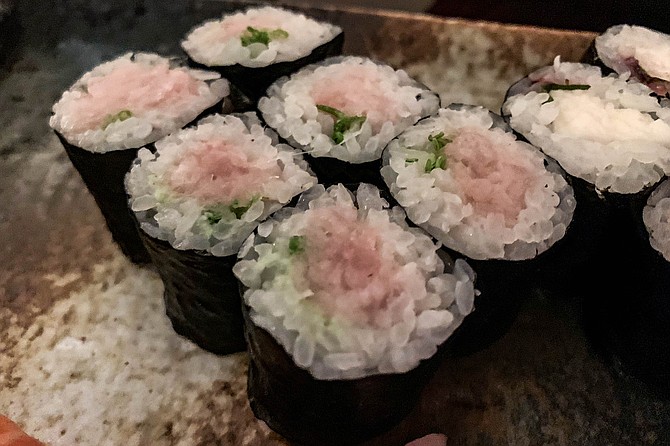 Green wasabi contrasts with pink yellowtail in this negi hamachi roll.