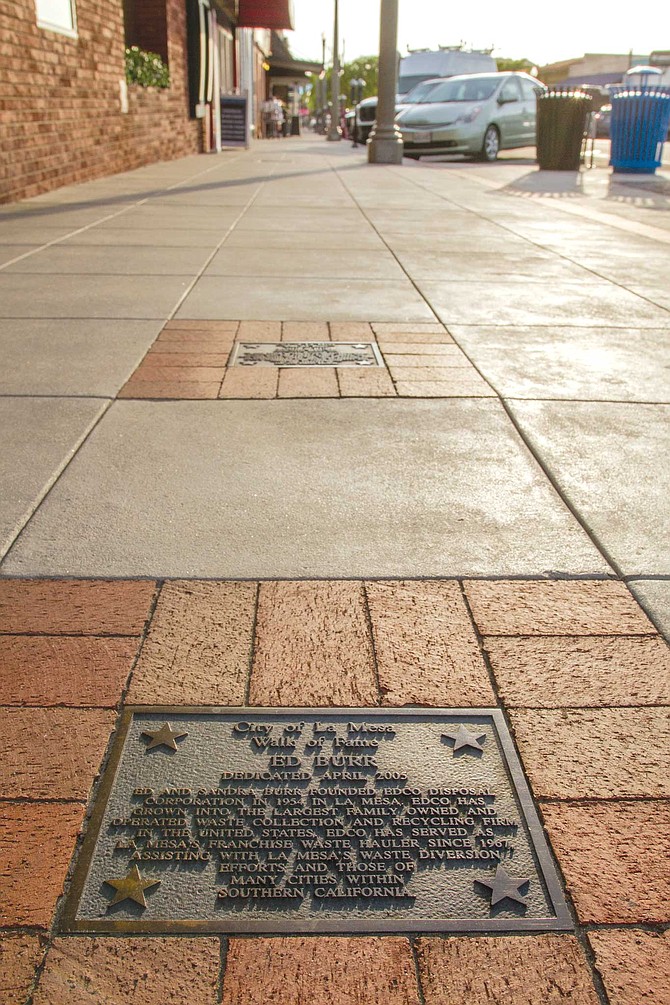The Walk of Fame consists of small bronze plaques embedded in Village sidewalks. Names include auto dealer Elmer Drew, EDCO founder Ed Burr, and shuttle astronaut Ellen Ochoa.