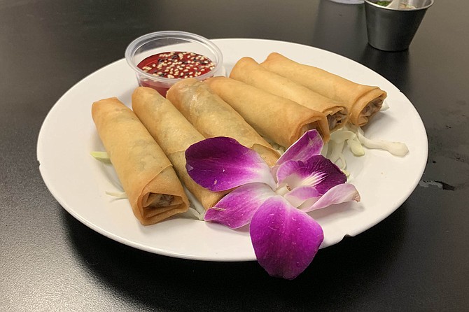 Beef lumpia, served with a purple orchid