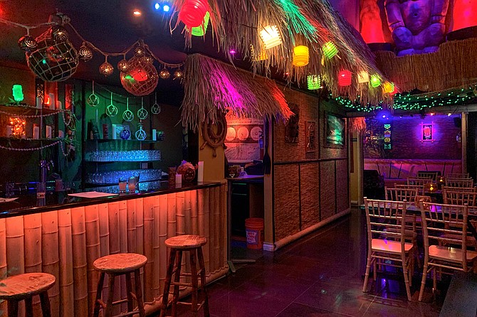 A colorful tiki bar speakeasy where blacklights are just the beginning