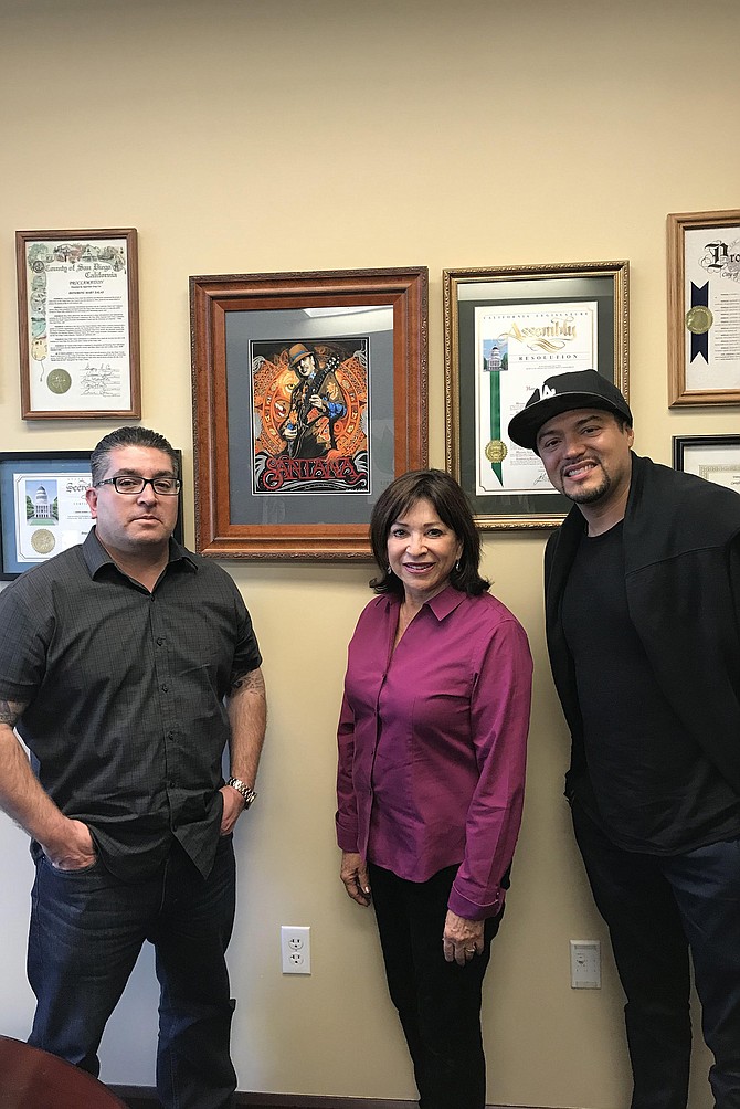Torres, Chula Vista Mayor Mary Salas, and Santana singer Andy Vargas with Enrique Rivera’s painting.