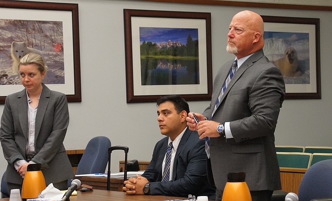 David Carpio, seated; his attorney, Sean Leslie, standing