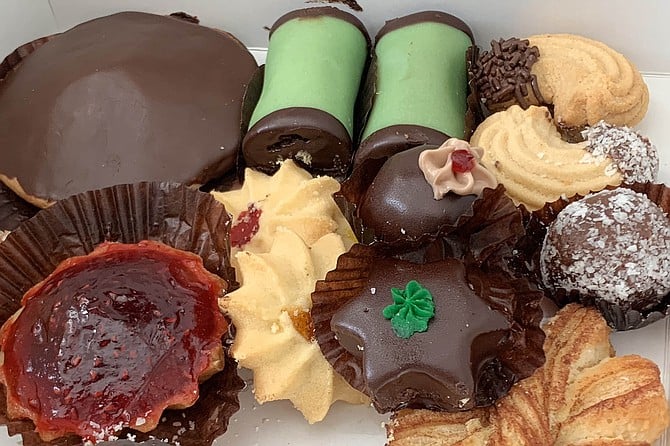 A box of Swedish baked goods including (clockwise from bottom left) mazarin, chokladbiskvi, and punchrulle