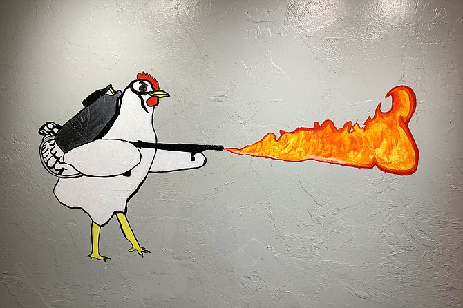 A chicken with a flame thrower at FireBirds Hot Chicken