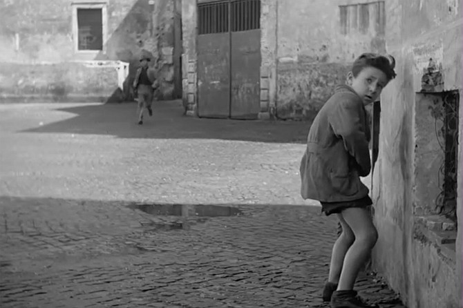 The Bicycle Thieves: Enzo Staiola pulls up a wall in the shot in question.