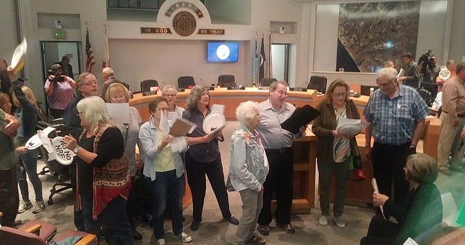 Larry Kornit (center, white shirt) and other Oceanside locals use Beatles tune with an anti-North River Farms chorus "Can't buy our vote"  at November 6 city council meeting.
