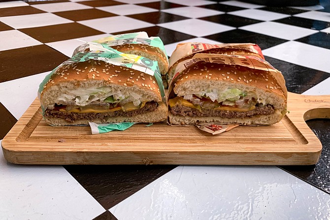 Split in half, we can see minor differences between patties on these Whoppers with cheese.