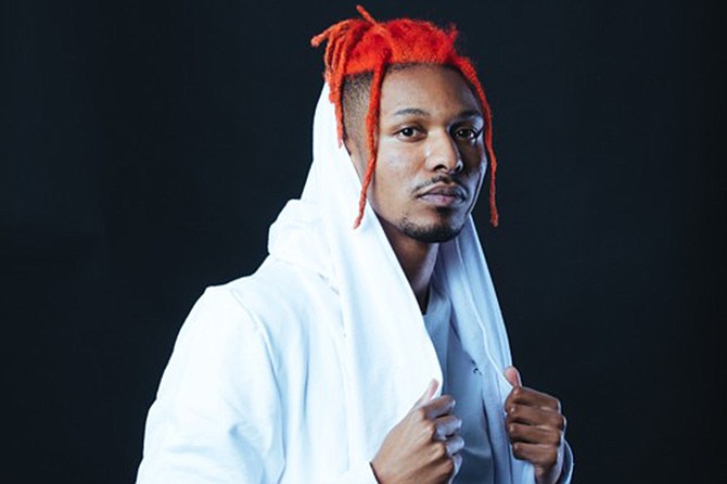 The 6’5” SAYMYNAME, born Dayvid Lundie-Sherman, is known for bobbing his red dreadlocks while on stage.