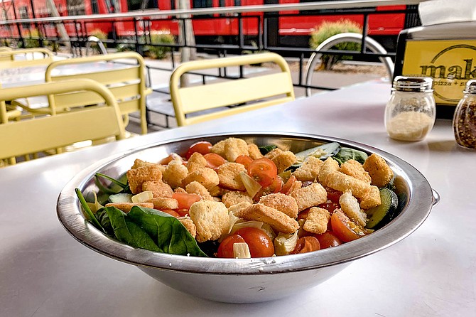 A custom built salad, with baby spinach, assorted vegetables, and croutons