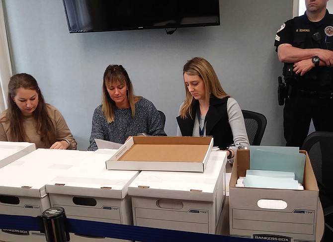City of Oceanside employees oversee the preliminary tallying of signatures to reverse the North River Farms project.