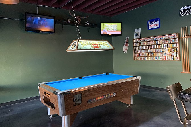 A pool table in the corner, more TVs to come