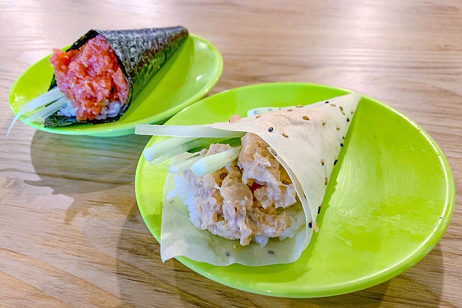 A rice paper hand roll, and a traditional nori hand roll