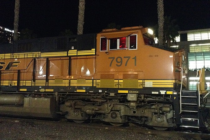 Heavy diesel trains like this shake up the Del Mar bluffs many times daily