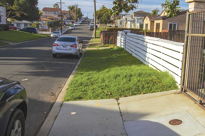 “See there? Sidewalk, then no sidewalk . . . sidewalk, then no sidewalk.” The reason: Paradise Hills was once part of the county, which did not require concrete paths, unlike the city proper.