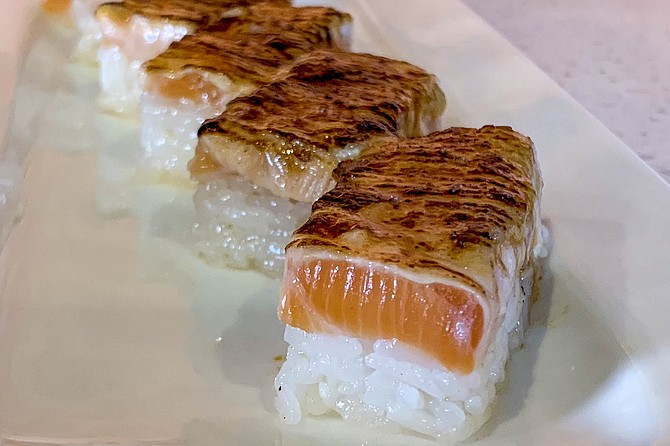 Salmon oshi aburi sushi: pressed into box-shapes and charred with a blowtorch