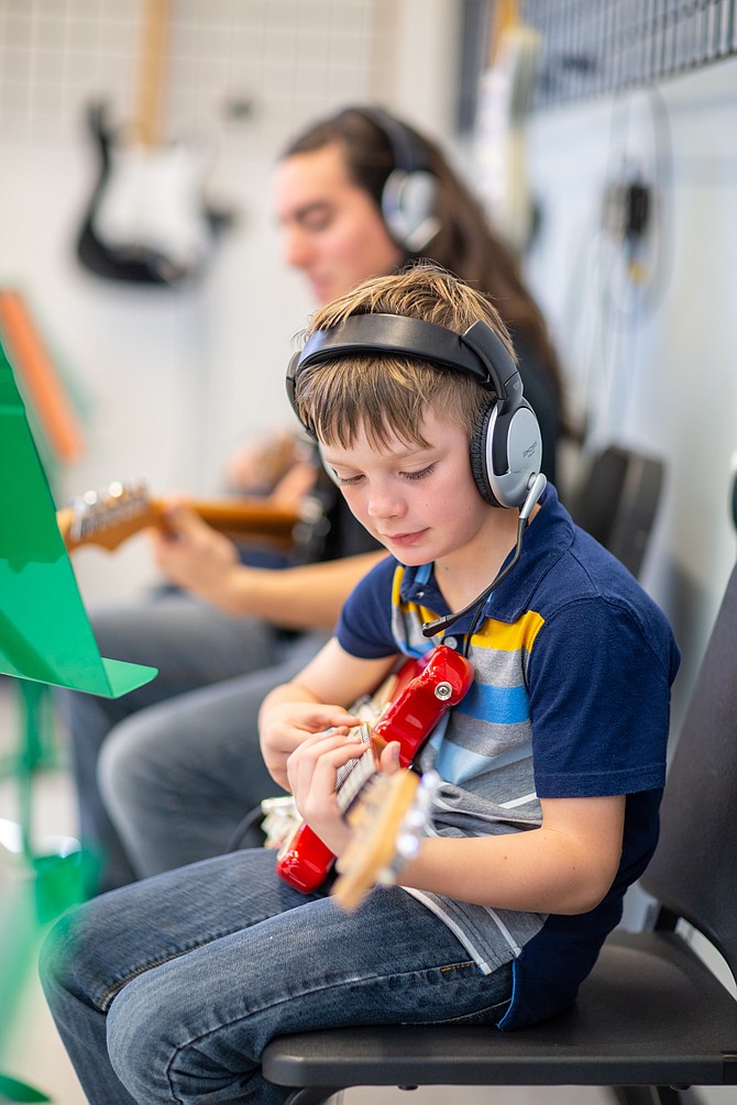 Kids get hands-on experience with guitar, drums, piano and more.
