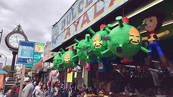 Candy shops created COVID-19 piñatas with a crude drawing of the face of a Chinese man pasted on a virus-shaped piñata.