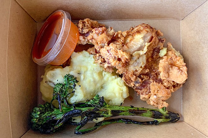 Fried chicken, mashed potatoes, and broccolini, made by Mission Avenue Bar & Grill for folks in need